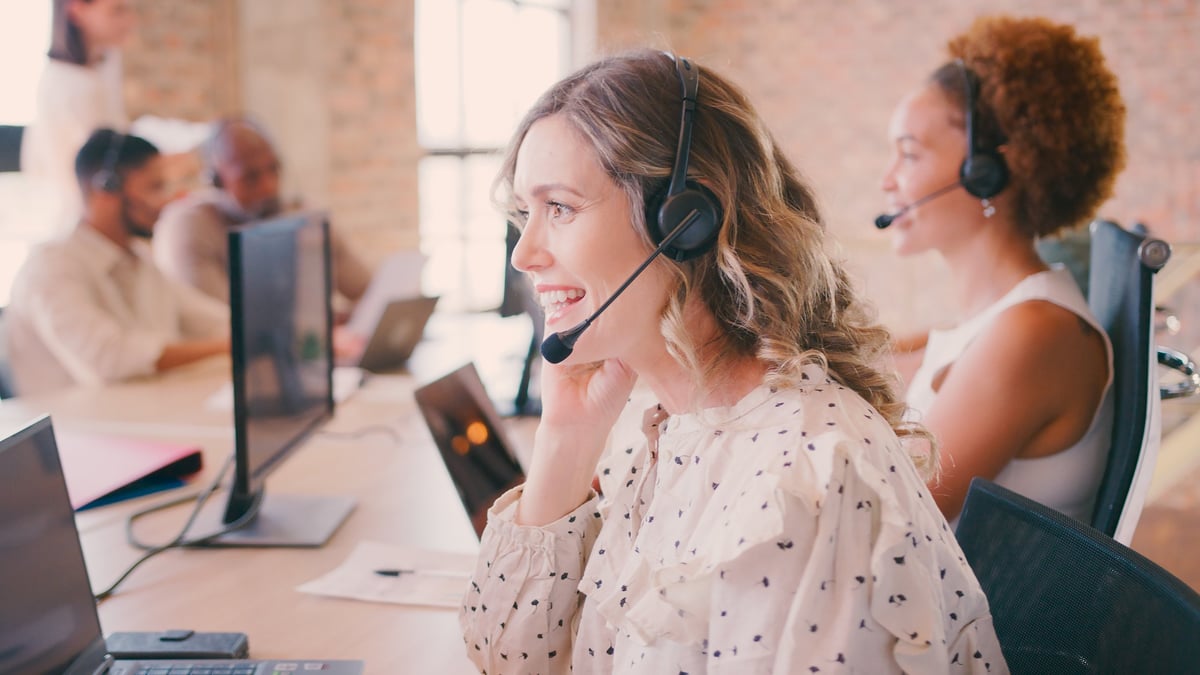 Customer support specialist managing calls with a headset